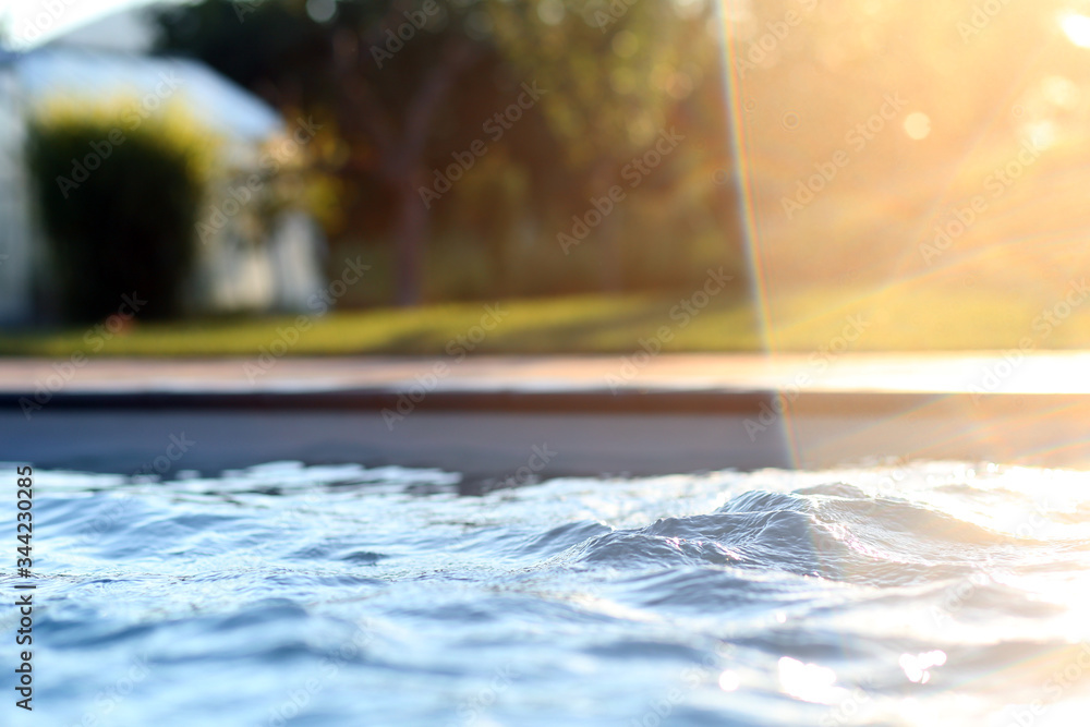 Detail on water in the pool with sunlight flare Detail on water in the pool with sunlight flare