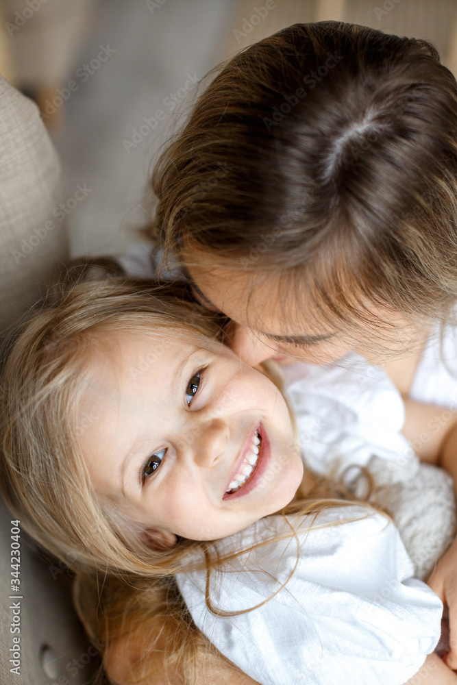 Mother's love. Mom hugs her little daughter. Maternal hugs. Female portraits close-up. The concept of female happiness Mother's love. Mom hugs her little daughter. Maternal hugs. Female portraits close-up. The concept of female happiness