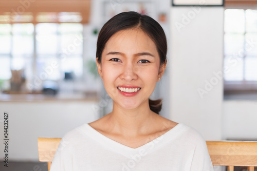 Portrait young Asian businesswoman work at home and virtual video conference meeting with colleagues business people, online working, video call, camera view, front view, look at camera