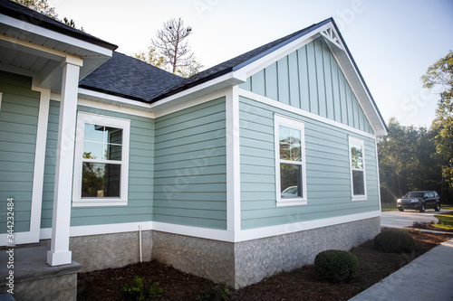 Fotografija Front view of a brand new construction house with blue siding, a ranch style hom