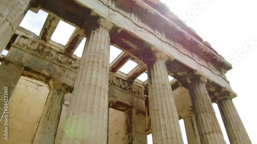 Right to left pan and tilt camera moves slowly around the Temple of Hephaestus in The roman agora of Athens photo