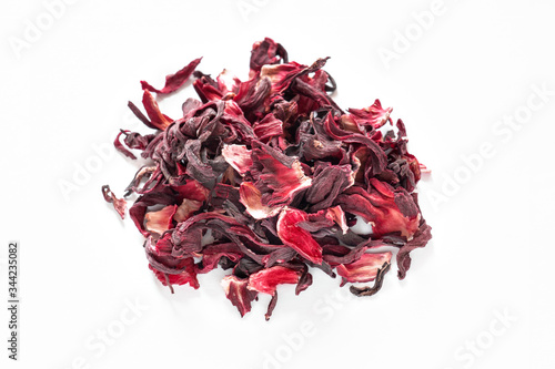 Hibiscus red tea, dried hibiscus flower petals on a white background, traditional Egyptian drink