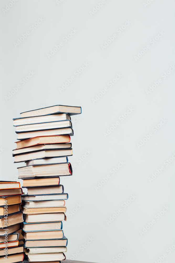 a lot of stacks of educational books for college on a white background a lot of stacks of educational books for college on a white background