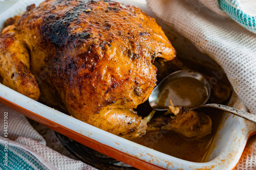 Hot baked chicken with a delicious brown fried crust. Cooked fried poultry, watering with its own juice and fat. Rich orange color of meat.