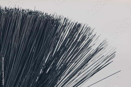 A closeup of a bristle brush. The texture of thin plastic rods. Graphic black lines. Black rods