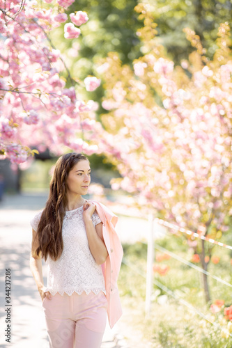 beautiful bright girl in saturated sakura