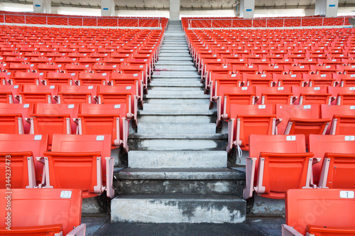 Empty orange seats at stadium,Rows walkway of seat on a soccer stadium