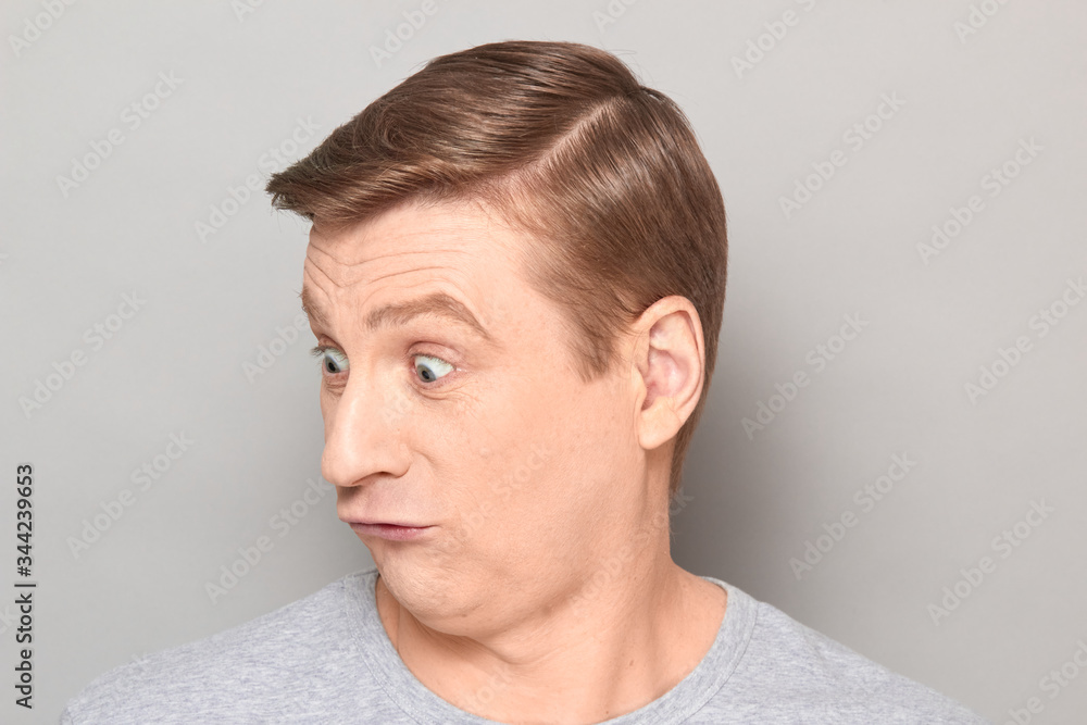 Portrait of blond mature man with fool goofy perplexed expression Portrait of blond mature man with fool goofy perplexed expression