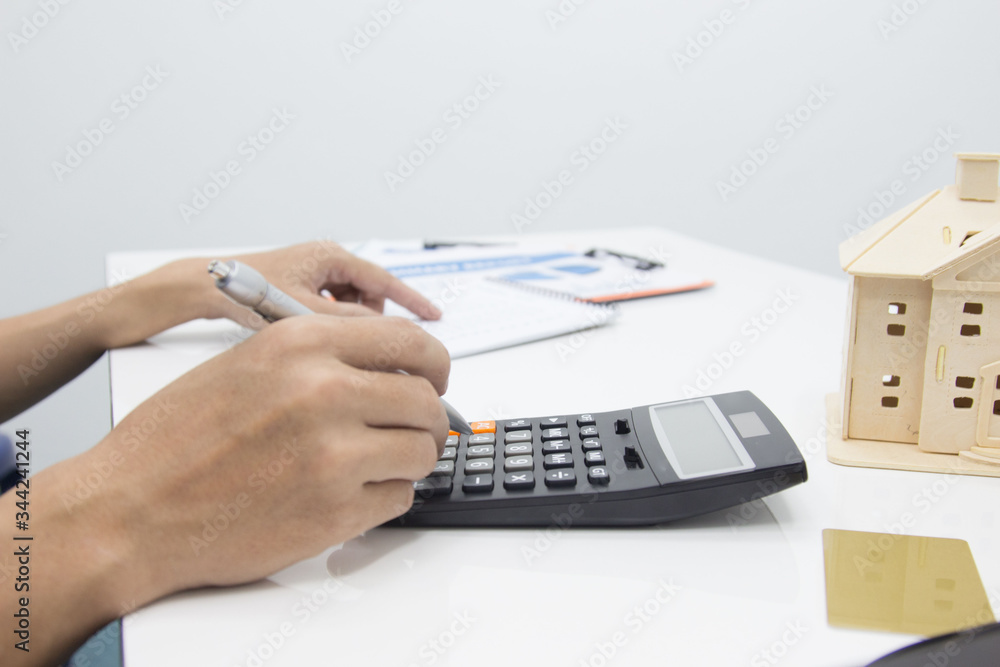 Business man doing finances and calculate on desk about cost at work office.payment concept. Business man doing finances and calculate on desk about cost at work office.payment concept.