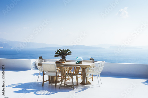 Minimalist architecture, outdoor Table, terrace with caldera view, Oia, Santorini island, Cyclades, Greece