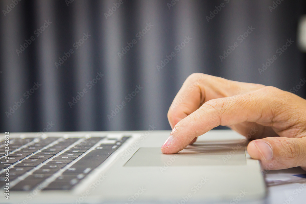 Closeup business man hands searching for data on Notebook with analyzing charts at his workplace. Closeup business man hands searching for data on Notebook with analyzing charts at his workplace.