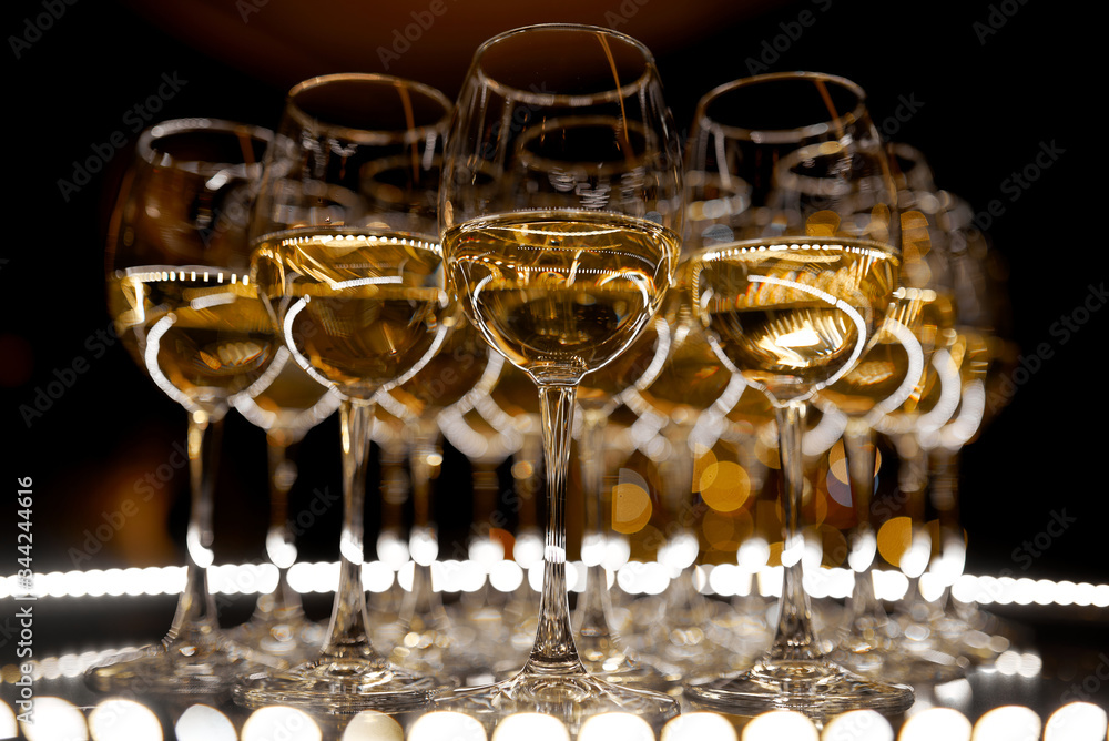 A table filled with wine glasses A table filled with wine glasses