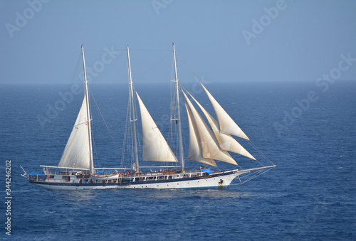 Tall-ship Mandalay sailing in the Caribbean with jibs and mizzen sails set.