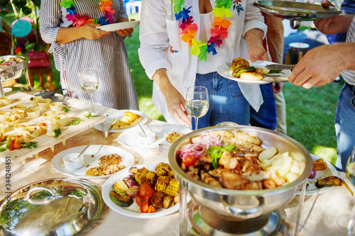 Hands take food at a party