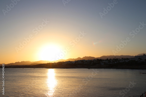 Scenic sunset in Sharm El Sheikh. The sea  mountains and giant sunset sun view. The atmosphere of relaxation and freedom. Perfect vacation