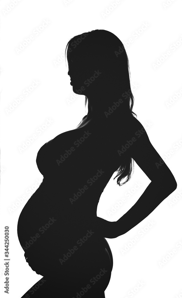 Silhouette of pregnant woman. Backlit black and white profile view