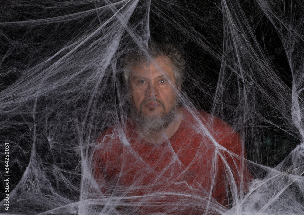 Naklejka premium man in a white spider web on a black background