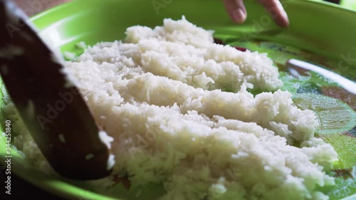 old lady mixing sticky rice with sugar and others ingredient. making of Thai mango sticky rice. traditional thai food. 