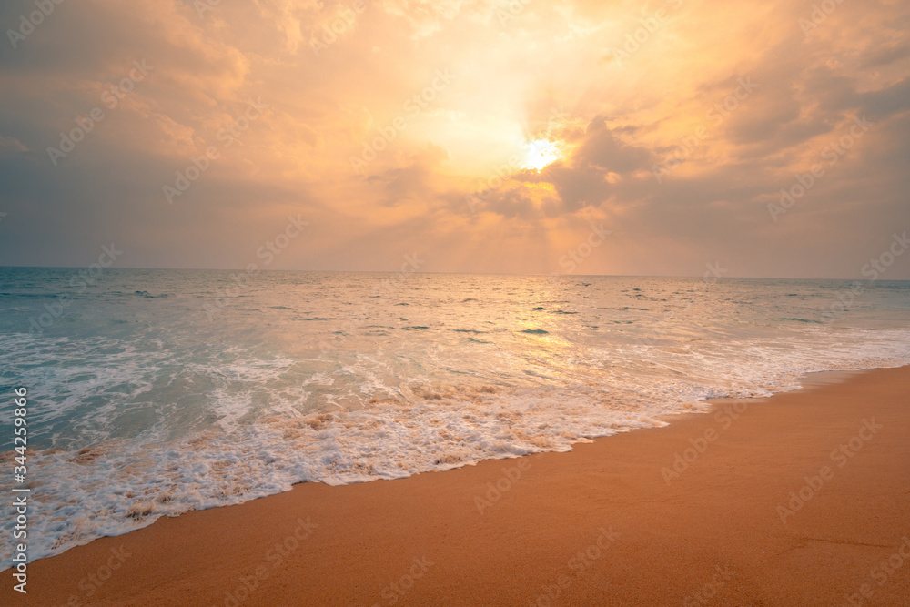 Foamy waves on sandy ocean beach under a beautiful sunset sky with clouds on Sri Lanka island. Foamy waves on sandy ocean beach under a beautiful sunset sky with clouds on Sri Lanka island.