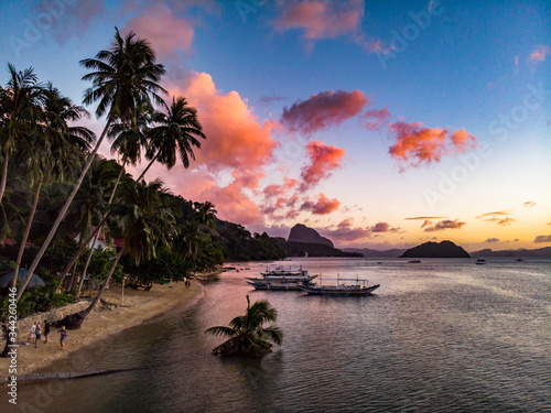 Tropical beach after sunset with pink clouds