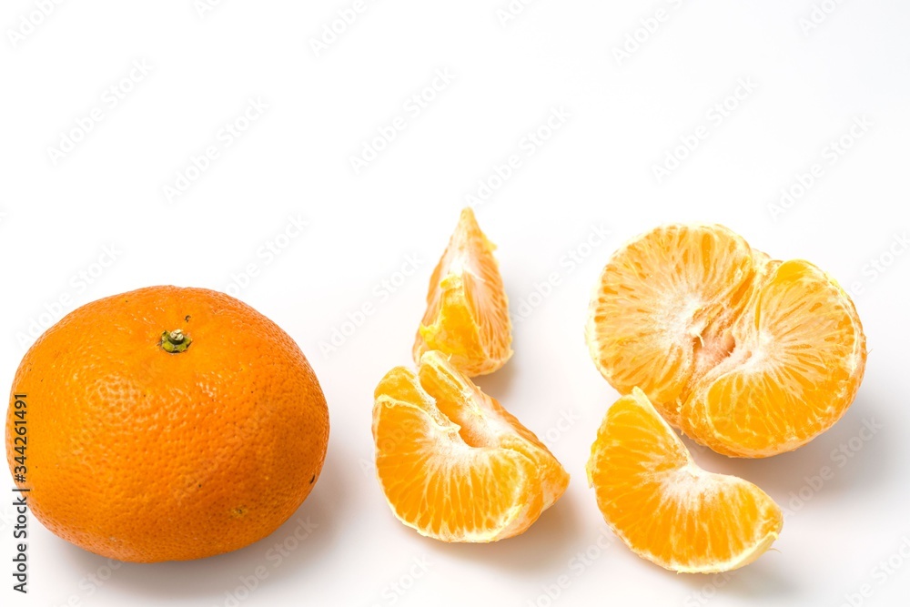 Close up macro view of whole and peeled mandarin on white background. Organic food concept. Healthy food concept. Close up macro view of whole and peeled mandarin on white background. Organic food concept. Healthy food concept.