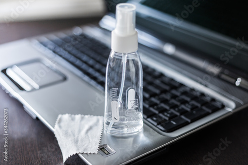 Using a medical antibacterial antiseptic gel in the workplace while working online at home at the computer. Protection at coronavirus and covid