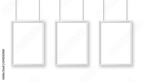 Realistic hanging on a wall white blank picture frame. Modern poster mockup. Empty photo frame. Vector illustration.