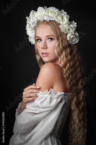 beautiful long haired blonde girl in flower crown and white dress