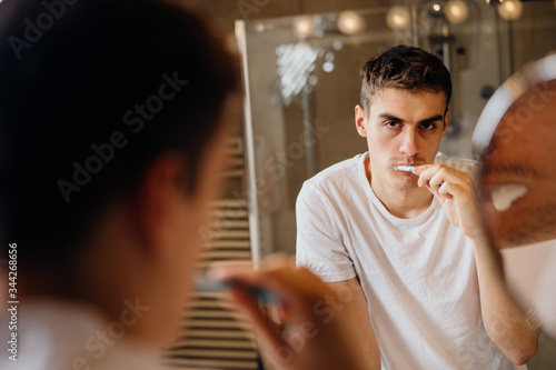 Fotografia Bored man brushing teeth,sad,tired