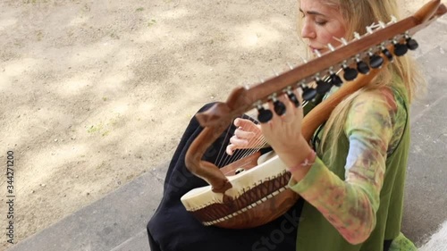 Female playing lyre on steps photo