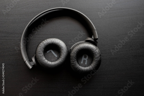 black headphones on black table or background. flat lay. table top view. copy space. - musical concept 