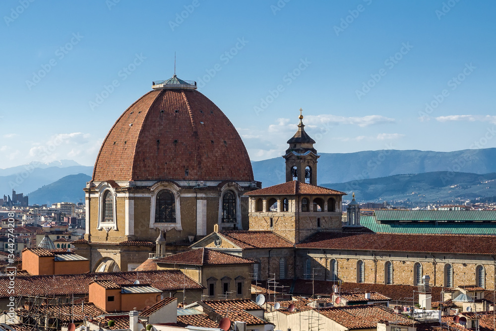 Fototapeta premium The dome of the Cappella dei Principi dominates the San Lorenzo architectural complex (Medici Chapels). Aerial view from Giotto's Campanile. Florence, Tuscany, Italy.