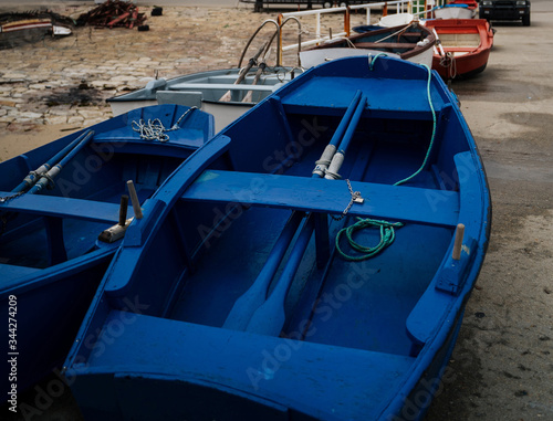 Wallpaper Mural Blue wooden boats in harbour with traditional houses from northern spain coast Torontodigital.ca