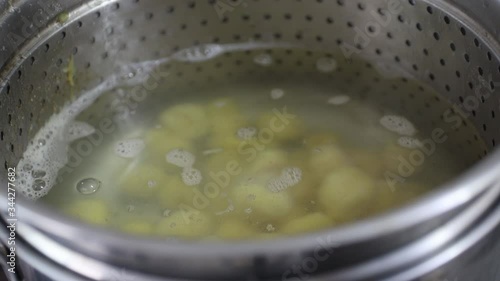 Cooking baroa potato gnocchi in a pan. Boiled Water. photo