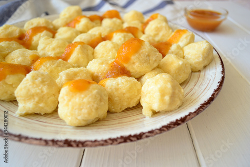 Home made sweet cottage cheese lazy dumplings (vareniki) with apricot jam on top.