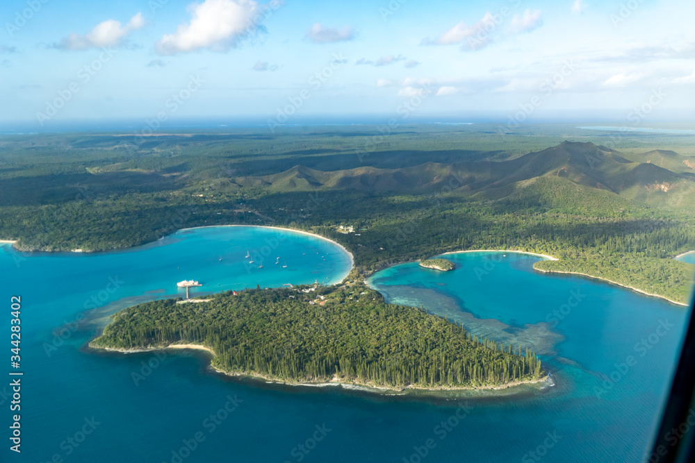 aerial view of isle of pines off the coast of new caledonia. Some boats on turquoise bay