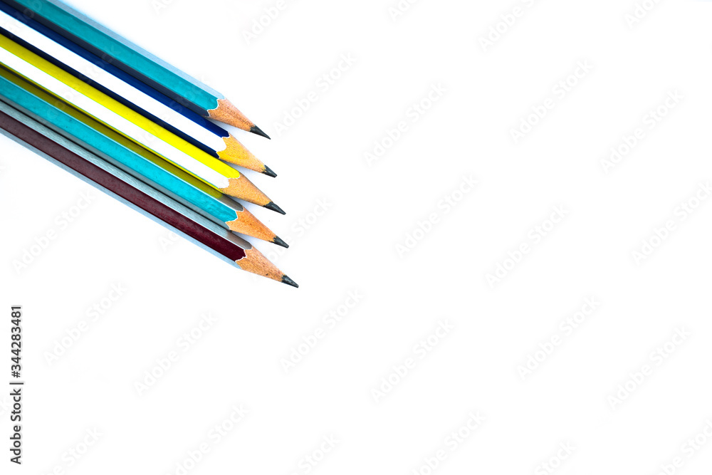 Five different colored wood pencil crayons arranged on a white background