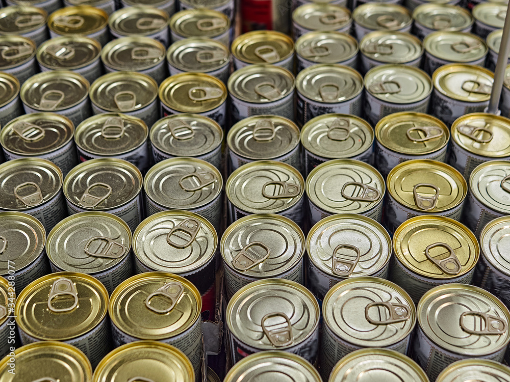 Iron cans with canned goods in a store on the counter. A lot of goods in the supermarket Iron cans with canned goods in a store on the counter. A lot of goods in the supermarket