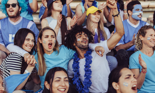 Argentinian spectators in stadium cheering their team photo