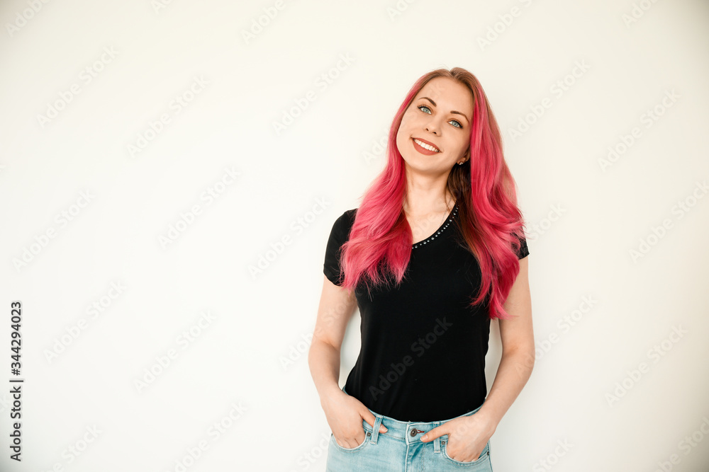 A photo of stylish trendy-looking young woman of European appearance. Bright pink hair, happy and modern student. A photo of stylish trendy-looking young woman of European appearance. Bright pink hair, happy and modern student.