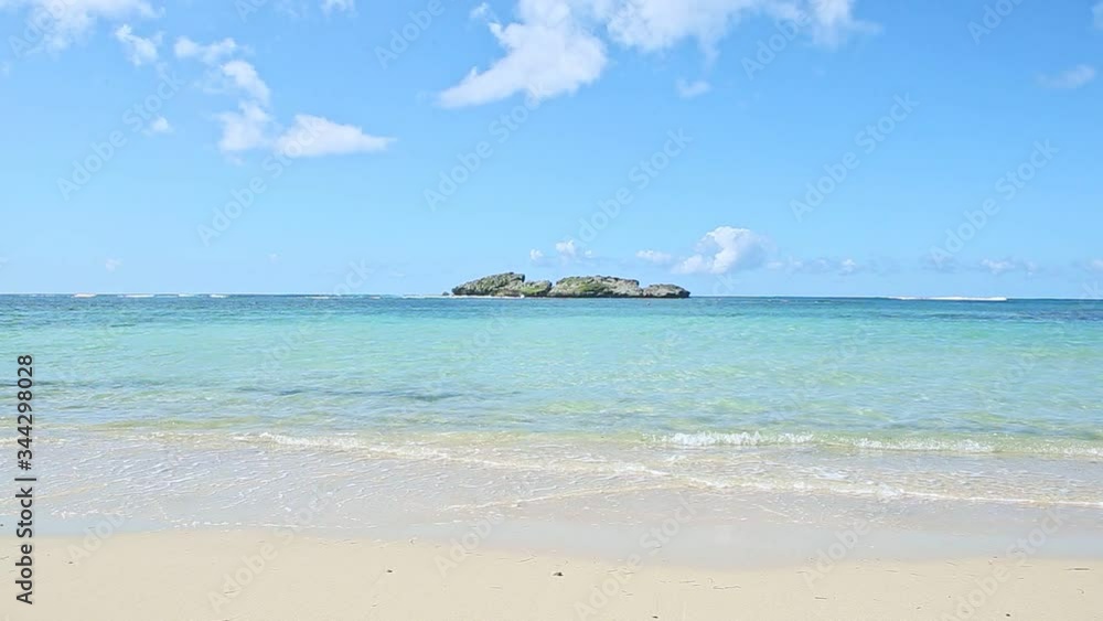 landscape view of white waves in blue ocean break up at clear golden sandy beach landscape view of white waves in blue ocean break up at clear golden sandy beach