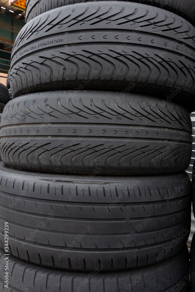 stack of used tires, the bottom has a directional asymmetrical tread pattern for all weather use, and the top two have directional, also called unidirectional, treads best for wet conditions stack of used tires, the bottom has a directional asymmetrical tread pattern for all weather use, and the top two have directional, also called unidirectional, treads best for wet conditions