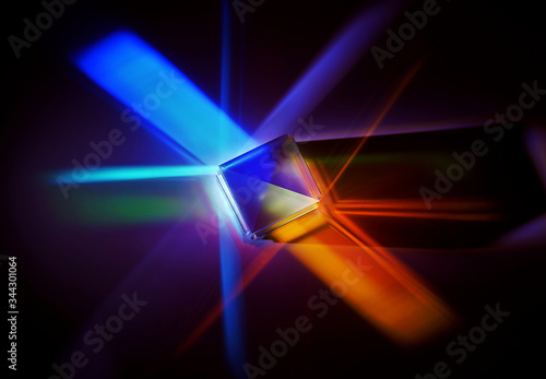 multicolored rays of light reflected by a crystal cube 