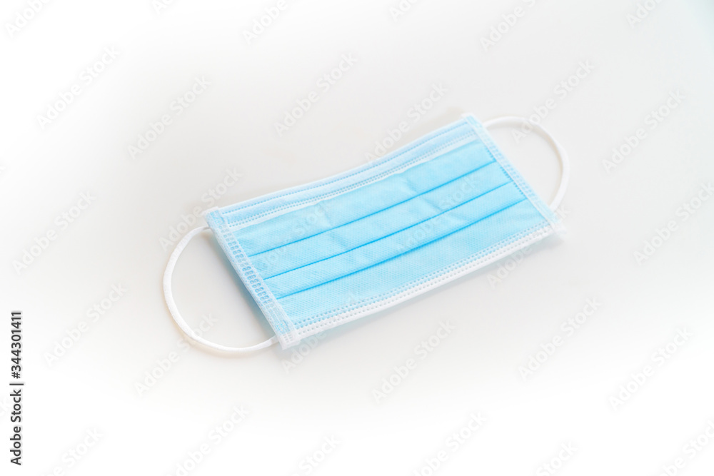 Disposeable blue Hygienic mask on white background protect from virus covid 19 n95 pollution Disposeable blue Hygienic mask on white background protect from virus covid 19 n95 pollution