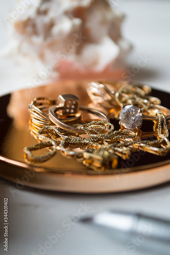 Golden accessories and pen, close up. 
