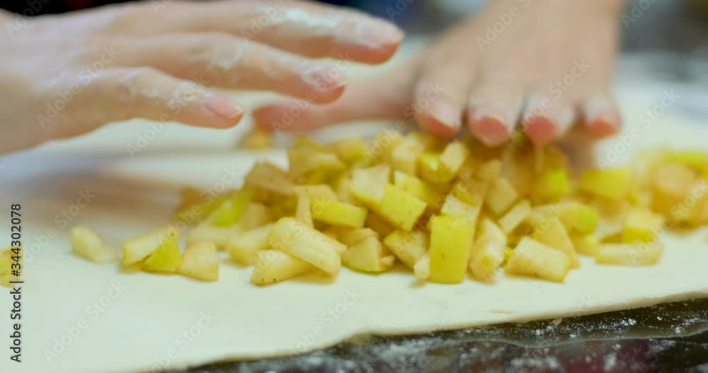 close up of woman's hands make a apple pie close up of woman's hands make a apple pie
