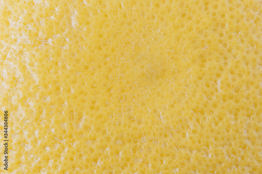 Macro close-up of a ripe yellow grapefruit. Abstact full frame textured background.