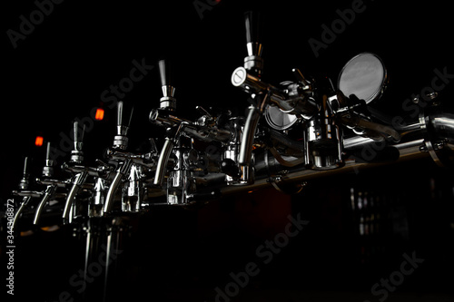 Beer taps bar brewery pints. many beer taps in bar or pub