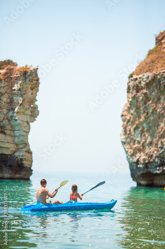 Sporty attractive family kayaking on sea together