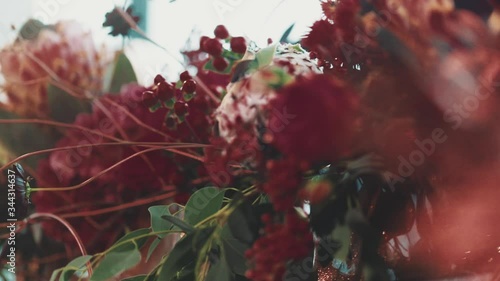 Beautiful bouquet made of fresh eucalyptus and red flowers, floral centerpiece composition on the banquet celebration, decoration of an wedding arch